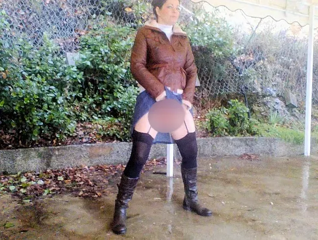 Öffentliches Pissen in Neckholder-Rock und Strümpfen in schwarzen Stiefeln